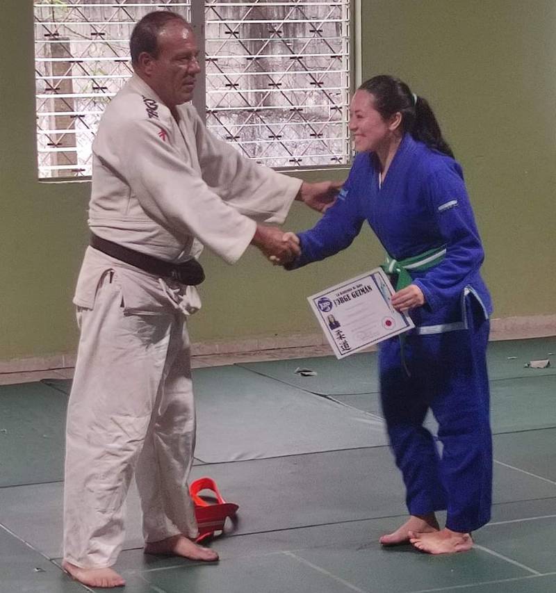 El maestro de Judo, Jorge Guzmán entrega diploma.