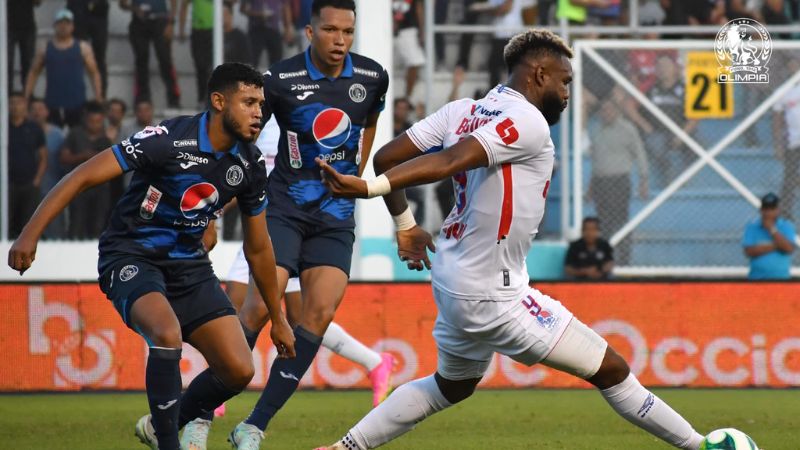 El delantero de Olimpia, Jorge Benguché, cubre el balón presionado por Marcelo Pereira.