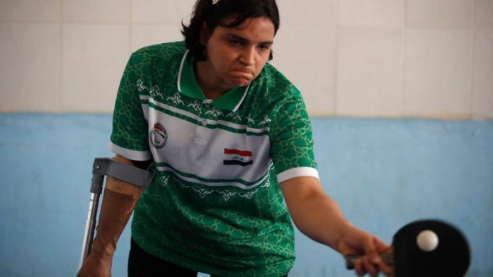 Najlah Imad, atleta de tenis de mesa paralímpica iraquí, hace ejercicios en las instalaciones del Club Al-Mawaheb en Baqubah.