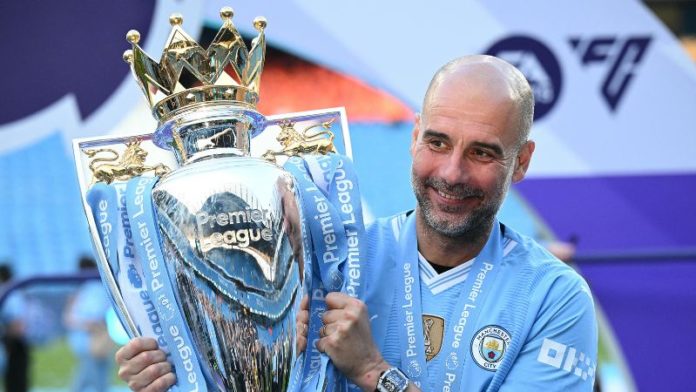 El técnico español del Manchester City, Pep Guardiola, posa con el trofeo de la Premier League.