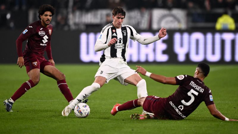 El delantero serbio de la Juventus, Dusan Vlahovic, lucha por el balón con el defensa marroquí de Torino Adam Masina.