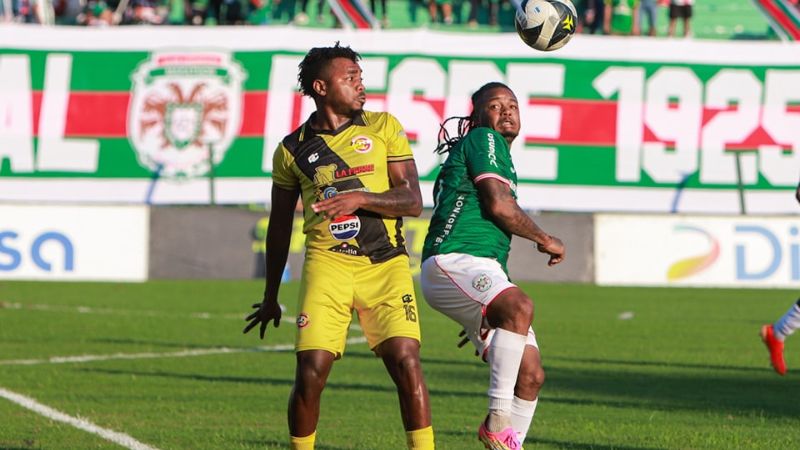 Elmer Güity y Yeer Gutiérrez disputan el balón en el centro del campo. 