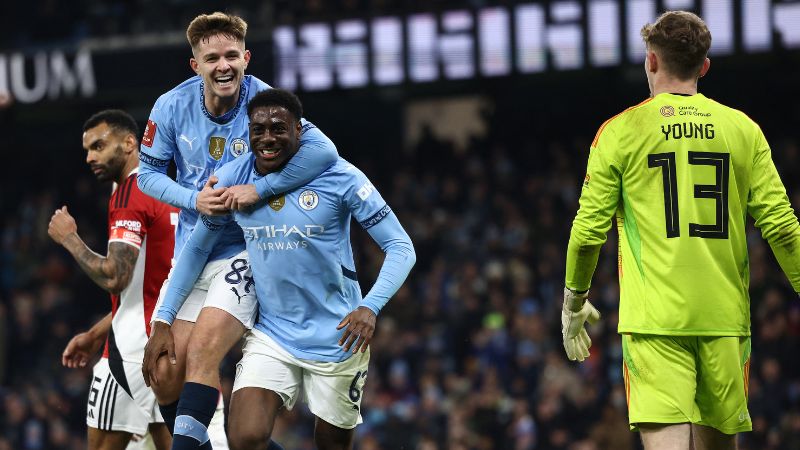 El delantero inglés del Manchester City Divin Mubama celebra anotar el segundo gol del equipo con el mediocampista James McAtee.