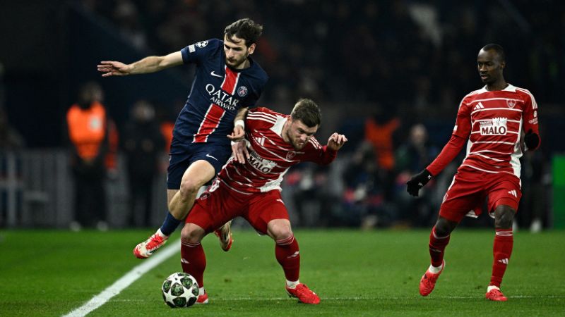 El delantero georgiano del Paris Saint-Germain, Khvicha Kvaratskhelia, y el centrocampista francés del Brest, Hugo Magnetti, luchan por el balón.