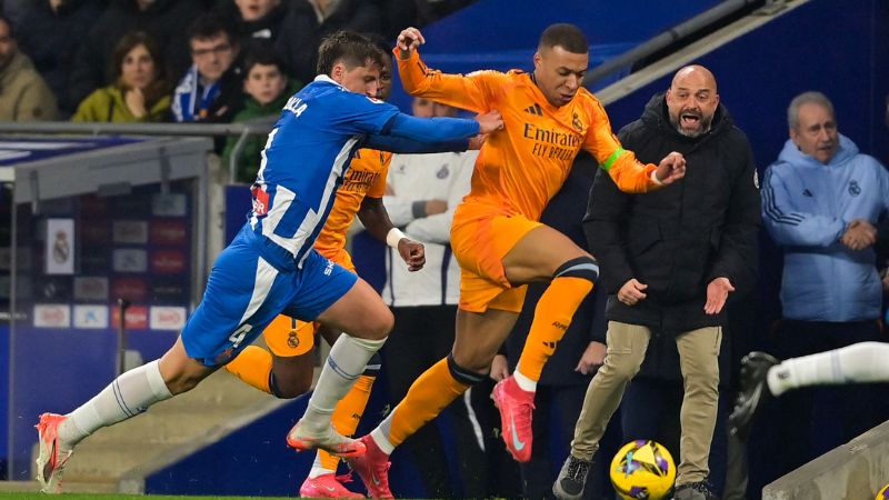 El delantero francés del Real Madrid, Kylian Mbappé, es marcado a presión por el defensa albanés del Espanyol, Marash Kumbulla,