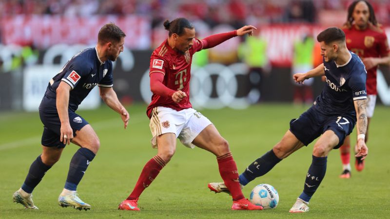 El delantero alemán del Bayern Munich, Leroy Sane compite por el balón con el defensor del Bochum, Maximilian Wittek y Agon Elezi.