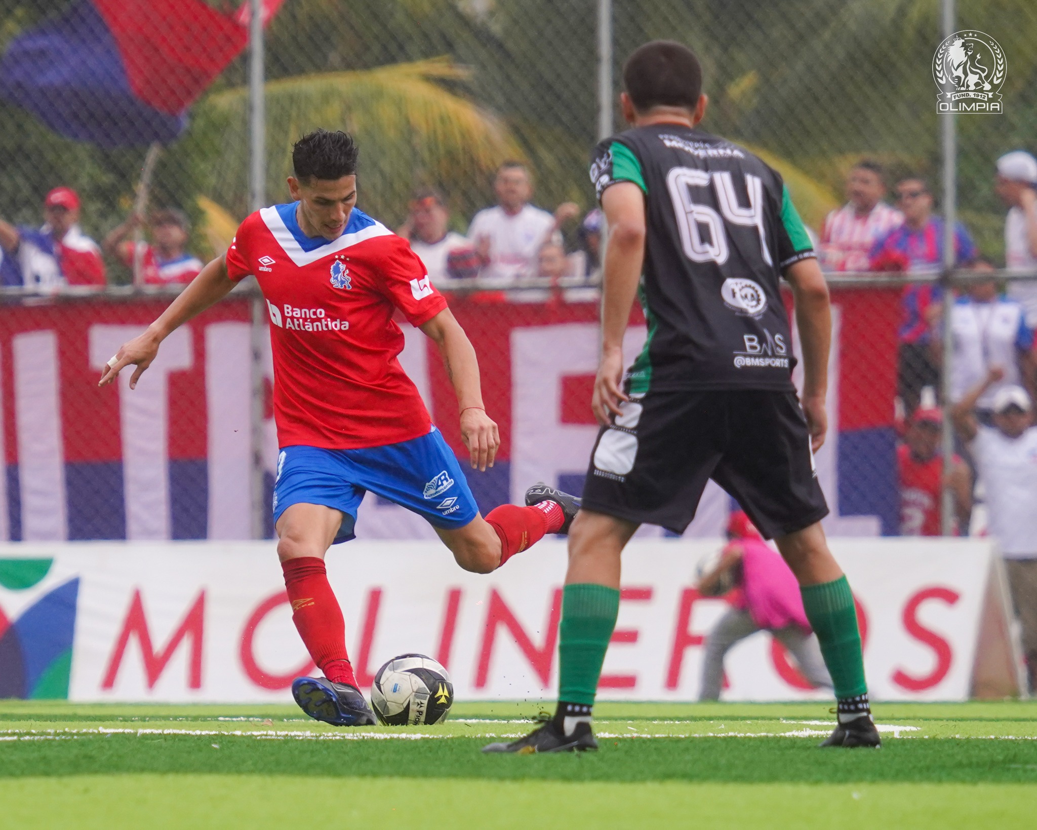 Emanuel Hernández, de Olimpia, controla el balón ante la mirada de Jeffy Martínez, de Juticalpa FC.