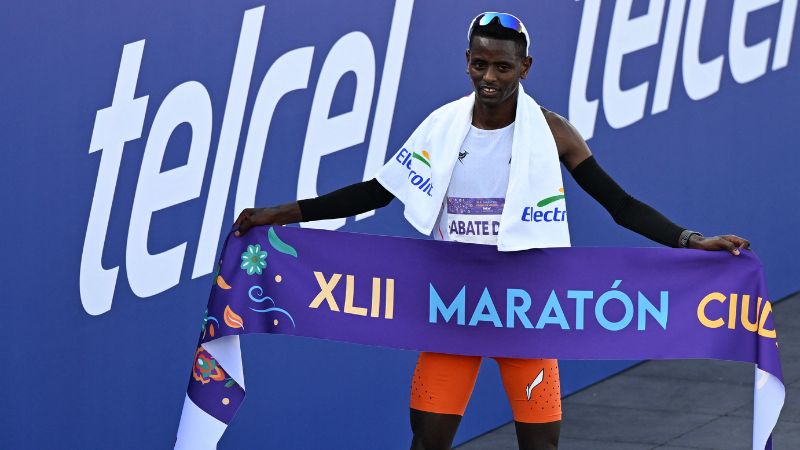 El corredor etíope Tadu Abate posa para una fotografía tras ganar el 42º Maratón Internacional de la Ciudad de México.