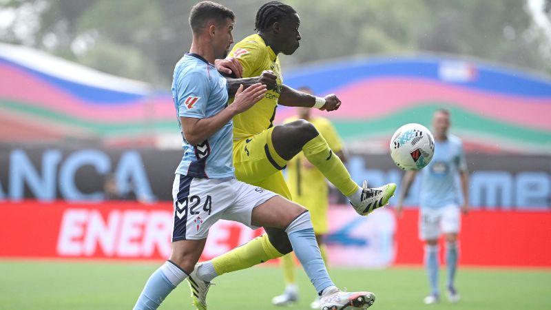 El defensa español del Celta de Vigo, Carlos Domínguez, disputa el balón con el delantero camerunés del Villarreal, Karl Etta Eyong.